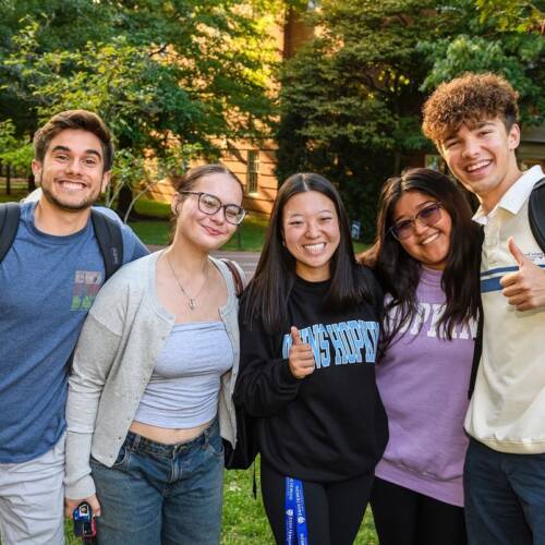 Five students pose for a photo