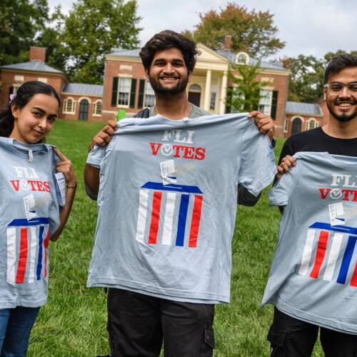 Three students pose with Hopkins Votes t-shirts