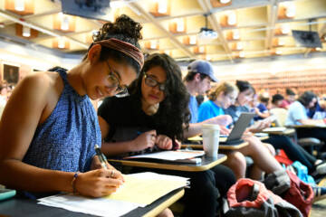 Students listen and discuss as Christov Roberson teaches the Introduction to Biology class.